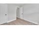 Bedroom with neutral walls, wood look flooring, and an open doorway at 13115 Meadowmere Rd, Huntersville, NC 28078