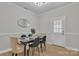 Inviting dining room features modern table setting, neutral tones and wood-look floors at 13115 Meadowmere Rd, Huntersville, NC 28078