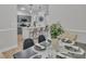 Dining area showcasing modern lighting, table setting, and view into adjacent kitchen at 13115 Meadowmere Rd, Huntersville, NC 28078