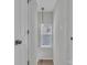 Bright hallway featuring natural light, neutral paint and wood look floors at 13115 Meadowmere Rd, Huntersville, NC 28078