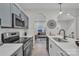 Sleek kitchen with stainless steel appliances and a view to living room at 13115 Meadowmere Rd, Huntersville, NC 28078