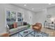 Stylish living room with a modern sofa, accent chair, and bright windows at 13115 Meadowmere Rd, Huntersville, NC 28078