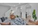 Inviting living room with staircase and a view to the kitchen at 13115 Meadowmere Rd, Huntersville, NC 28078