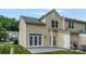 View of a backyard with a small concrete patio, white doors, and green lawn at 1326 Anthem Ct, Charlotte, NC 28205