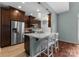 Modern kitchen with stainless steel appliances and breakfast bar seating at 1326 Anthem Ct, Charlotte, NC 28205