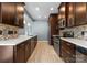 Modern kitchen with tile backsplash, stainless appliances, and quartz countertops at 1326 Anthem Ct, Charlotte, NC 28205