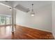 Bright living room featuring hardwood floors, pillars, and modern lighting at 1326 Anthem Ct, Charlotte, NC 28205
