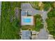 Aerial view of a community pool with lounge chairs, parking lot, and surrounded by lush greenery at 1326 Anthem Ct, Charlotte, NC 28205