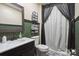 Modern bathroom showcasing vanity sink, stylish dark hardware, and a shower with a decorative curtain at 139 Sheep Path Dr, Mooresville, NC 28115
