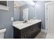 Stylish bathroom with a dark vanity, marble countertops, modern mirror and a great light fixture at 139 Sheep Path Dr, Mooresville, NC 28115