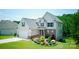 Charming two-story home with attached garage, lush lawn, and beautiful front yard landscaping at 139 Sheep Path Dr, Mooresville, NC 28115
