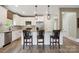 Modern kitchen with stainless steel appliances, granite countertops, and three counter chairs at 139 Sheep Path Dr, Mooresville, NC 28115