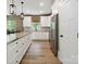 Bright kitchen with stainless steel appliances, granite countertops, and white cabinets at 139 Sheep Path Dr, Mooresville, NC 28115