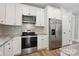 Modern kitchen with stainless steel appliances, granite countertops, and white cabinetry at 139 Sheep Path Dr, Mooresville, NC 28115