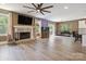 Spacious living room with fireplace, mounted TV, large windows, and hardwood floors at 139 Sheep Path Dr, Mooresville, NC 28115