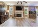 Spacious living room featuring a fireplace, ceiling fan and large windows letting in natural light at 139 Sheep Path Dr, Mooresville, NC 28115