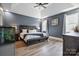 Cozy main bedroom featuring a ceiling fan, a king-size bed, and natural light from large windows at 139 Sheep Path Dr, Mooresville, NC 28115