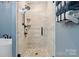 Modern shower with a glass door and a rainfall shower head and a pebble floor at 139 Sheep Path Dr, Mooresville, NC 28115