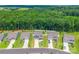 An aerial view shows neighborhood houses with well-manicured lawns backing up to a forest at 154 Tanner Loop, Troutman, NC 28166