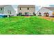 Expansive backyard with lush lawn, an outdoor living area, and fencing, provides privacy and space for recreation at 154 Tanner Loop, Troutman, NC 28166