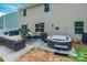 Inviting backyard featuring a hot tub, seating area, and well-maintained lawn for outdoor enjoyment at 154 Tanner Loop, Troutman, NC 28166