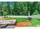 Expansive backyard featuring lush greenery and outdoor seating, perfect for relaxing and entertaining at 154 Tanner Loop, Troutman, NC 28166