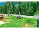 Spacious backyard offers an outdoor dining area, lush lawn, and privacy fencing, ideal for Gathering gatherings at 154 Tanner Loop, Troutman, NC 28166