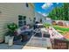 Comfortable outdoor patio with stylish furniture, a hot tub, and green surroundings creates a cozy retreat at 154 Tanner Loop, Troutman, NC 28166