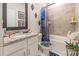Well-lit bathroom featuring a shower-tub combo, vanity with granite countertop, and elegant decor at 154 Tanner Loop, Troutman, NC 28166