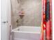 Bright bathroom showcasing a shower/tub combo with stylish tile and a colorful curtain at 154 Tanner Loop, Troutman, NC 28166