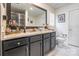 Modern bathroom featuring a sleek vanity with a granite countertop and a large mirror at 154 Tanner Loop, Troutman, NC 28166