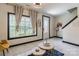 Bright open living room with white tile, large window and staircase at 154 Tanner Loop, Troutman, NC 28166