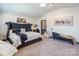 Cozy main bedroom with a large bed, soft carpet, and a chaise lounge for relaxation at 154 Tanner Loop, Troutman, NC 28166