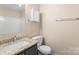 Bathroom includes a toilet, sink with granite countertop, mirror, and towel bar at 1620 #K Arlyn Cir # K, Charlotte, NC 28213