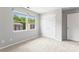 Bright bedroom featuring plush carpeting, neutral paint, and a double window providing ample natural light at 1620 #K Arlyn Cir # K, Charlotte, NC 28213
