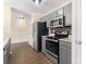 Modern kitchen features stainless steel appliances, gray cabinets, and granite countertops at 1620 #K Arlyn Cir # K, Charlotte, NC 28213