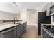 Updated kitchen features gray cabinetry, granite countertops, and stainless steel appliances at 1620 #K Arlyn Cir # K, Charlotte, NC 28213