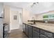 Modern kitchen with stainless steel appliances, granite countertops, and stylish gray cabinetry at 1620 #K Arlyn Cir # K, Charlotte, NC 28213