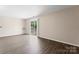 Spacious living area with modern wood flooring and sliding doors to a balcony with outdoor views at 1620 #K Arlyn Cir # K, Charlotte, NC 28213