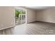 Bright living area with wood floors and sliding glass door leading to outdoor balcony at 1620 #K Arlyn Cir # K, Charlotte, NC 28213