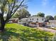 Lovely backyard view showcasing the lawn, a large tree, and the home's exterior at 1632 Kimberly Dr, Gastonia, NC 28052