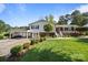 Charming home with a well-kept lawn, vibrant flowers, and a cozy front porch at 1632 Kimberly Dr, Gastonia, NC 28052