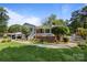 Charming home featuring a landscaped front yard, brick accents, and white picket fence at 1632 Kimberly Dr, Gastonia, NC 28052