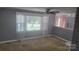 Bright living room featuring a large window with natural light and neutral decor at 1632 Kimberly Dr, Gastonia, NC 28052