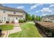 Townhome back entrance featuring a small yard and patio area at 17729 Trolley Crossing Way, Cornelius, NC 28031