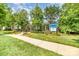 Charming Caldwell Station community clubhouse with inviting landscaping and mature trees at 17729 Trolley Crossing Way, Cornelius, NC 28031
