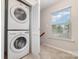 Convenient laundry room with stacked washer and dryer, tucked away behind shuttered doors at 17729 Trolley Crossing Way, Cornelius, NC 28031