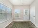Bright mud room featuring wood floors, a patterned rug, and natural light from two windows at 17729 Trolley Crossing Way, Cornelius, NC 28031