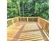 Wide shot of newly constructed wooden deck with wooden railing overlooking lush, green trees at 206 N Kayla Dr, Salisbury, NC 28146