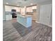 Bright kitchen boasts white cabinets, granite countertops, stainless steel appliances, and an island at 206 N Kayla Dr, Salisbury, NC 28146